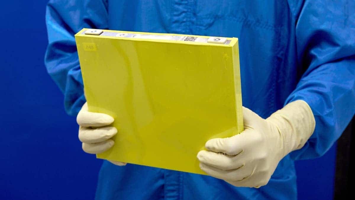 A General Motors LMR prismatic battery cell for use in EV trucks and SUVs being held by a lab worker.
